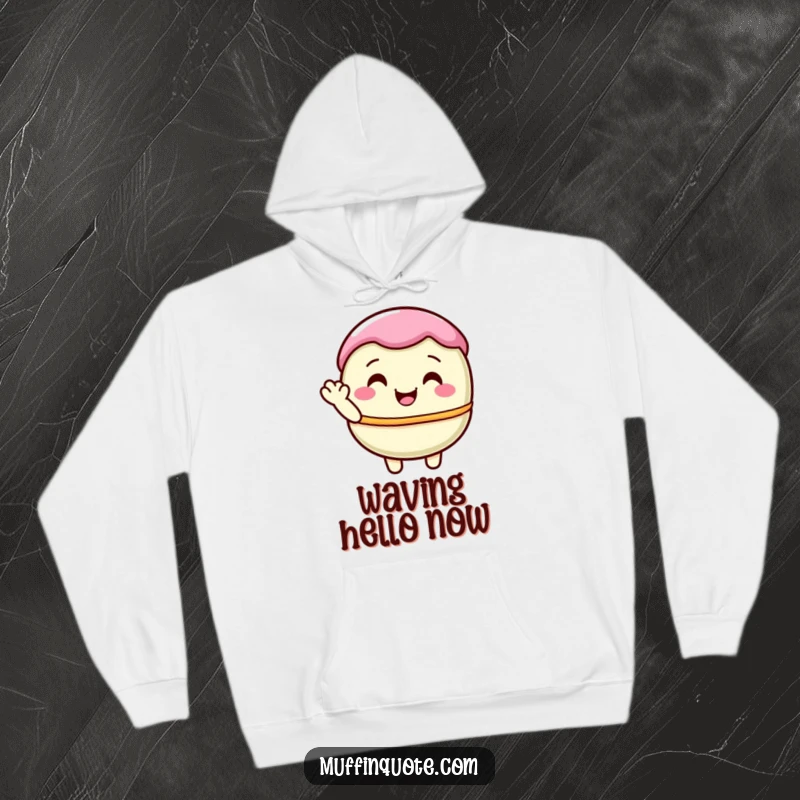 Funny, pastel-hued macaron character offering a shy wave, printed on a cozy hoodie for sweet comfort.