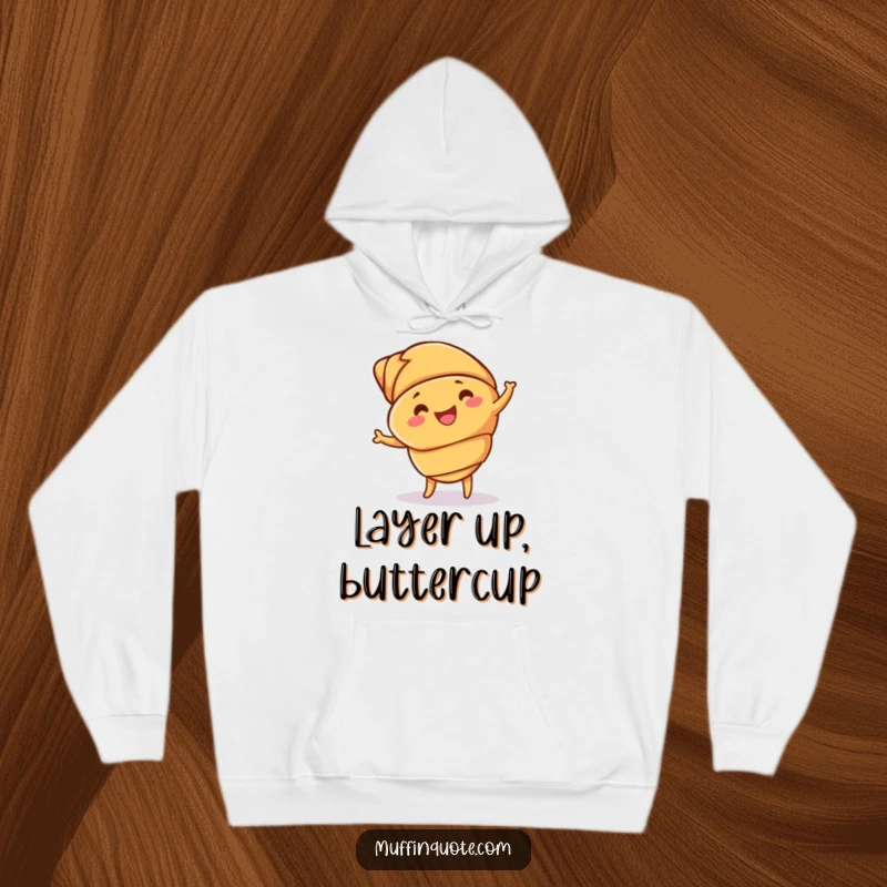 Funny croissant hoodie depicting a joyful, dancing pastry with detailed buttery layers, offering warmth and humor.
